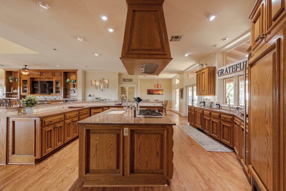 Open concept kitchen that opens up to wet bar area, living room, & pool table