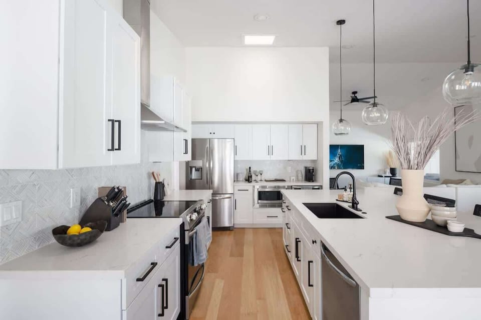 Open concept kitchen with stainless steel appliances, breakfast bar island seating, tons of natural light, and fully stocked with your basic cooking essentials.