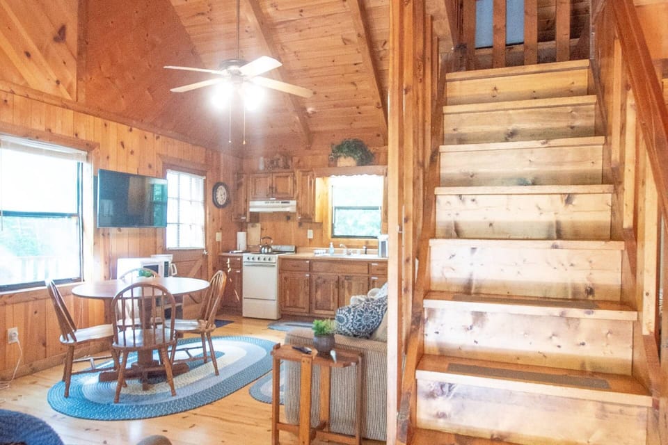 Walking in the front door, you are met with the steep steps up to the loft. Living space to your left and main bedroom/bathroom to your right.