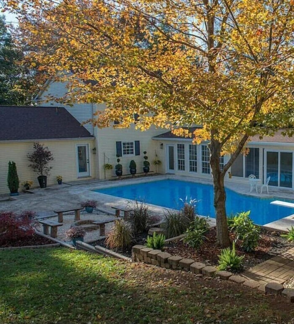 Large pool, fireplace, and fenced in yard.