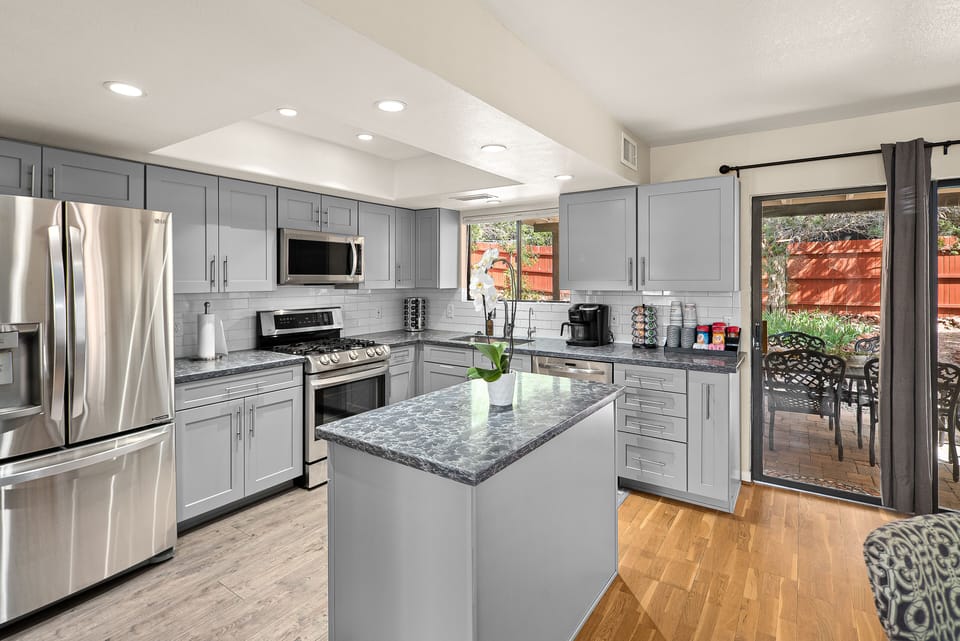 The kitchen features a fully stocked coffee station (drip and K-cup)