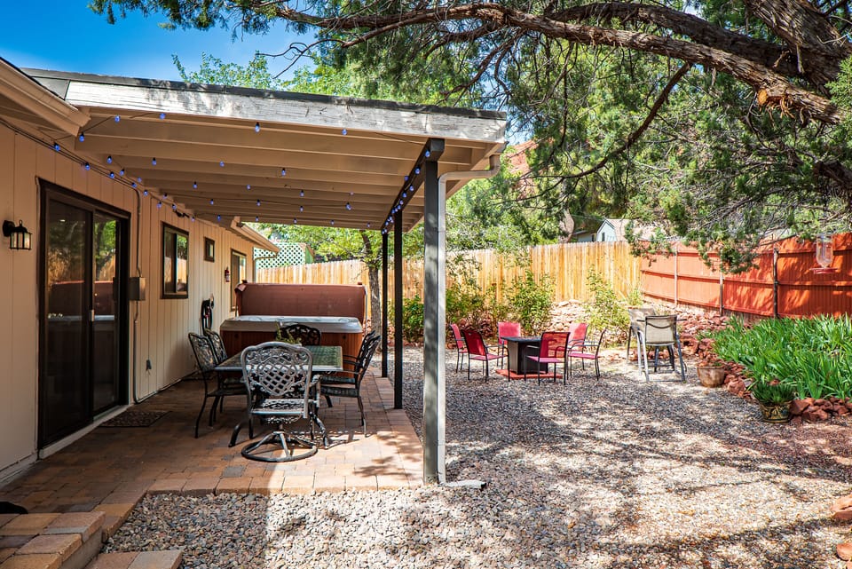 Our spacious backyard features outdoor seating, a hot tub, and a gas fire pit