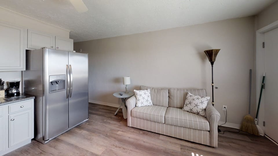 Simple kitchen setup with microwave, and full refrigerator