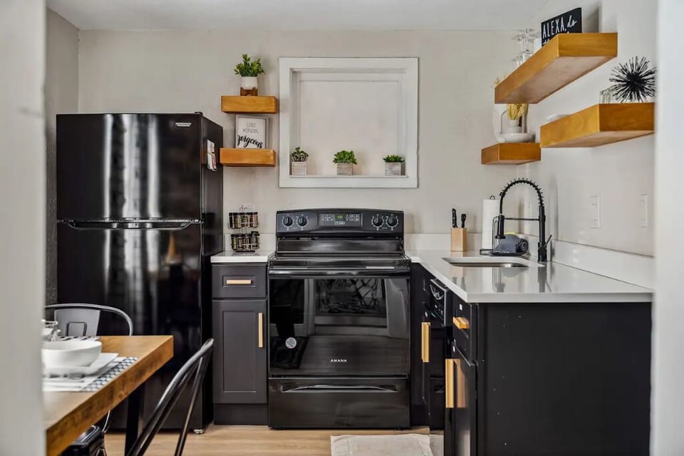 Cook with ease in a kitchen with full fridge, stove, and ample counter space.