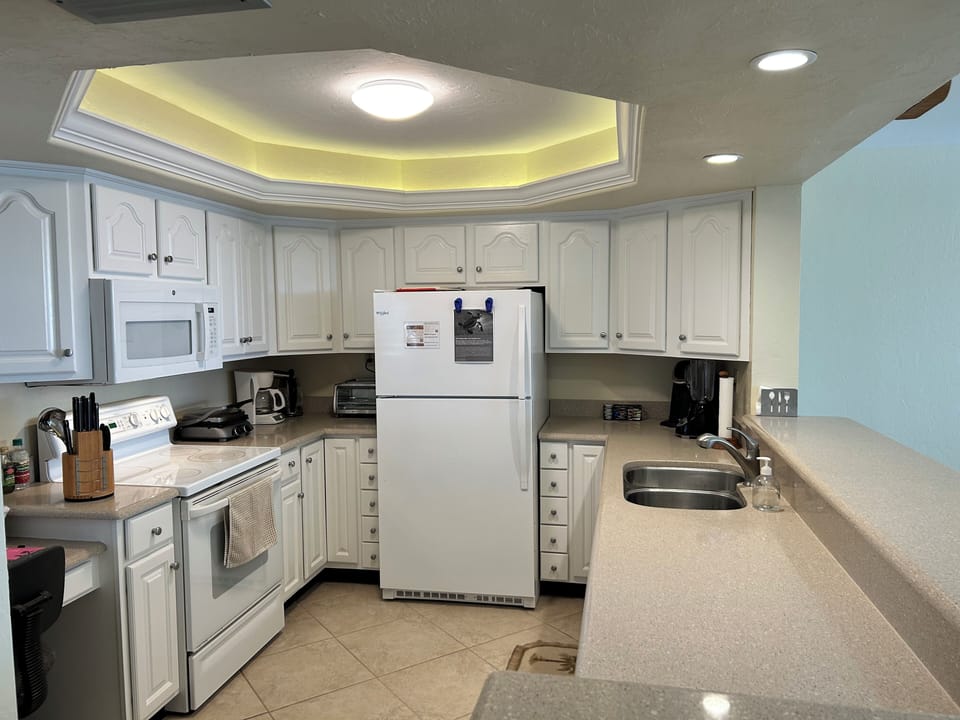 Kitchen-fully stocked with appliances, dishes, pans, cutlery, glasses, mugs,etc.