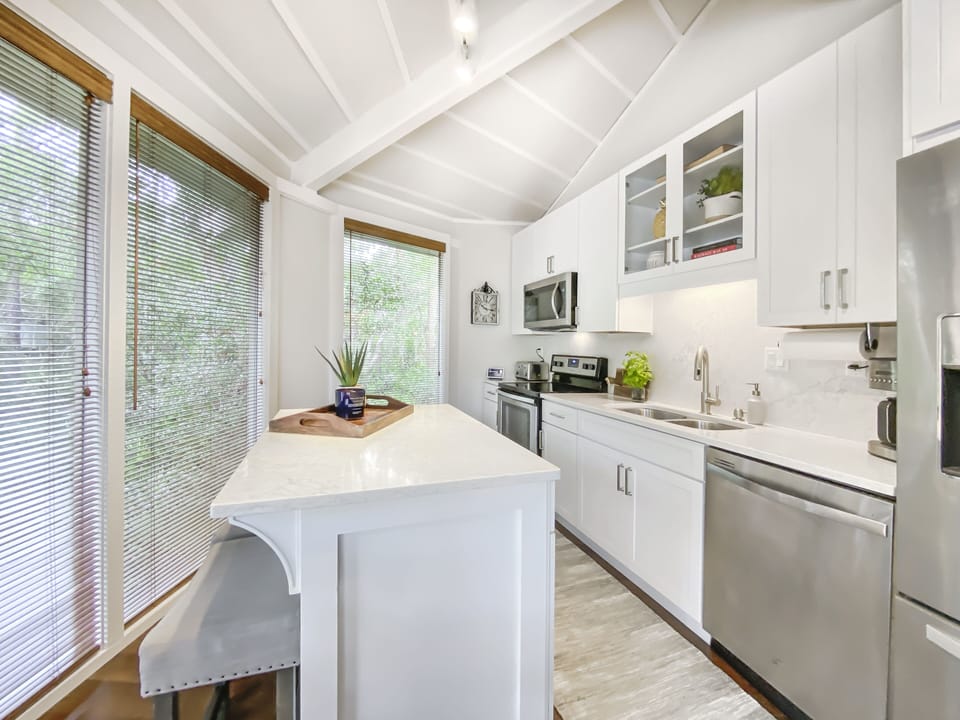 Stainless appliances and marble adorn this fully stocked kitchen.