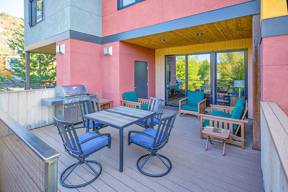 Main floor deck with BBQ and table for outdoor dining.