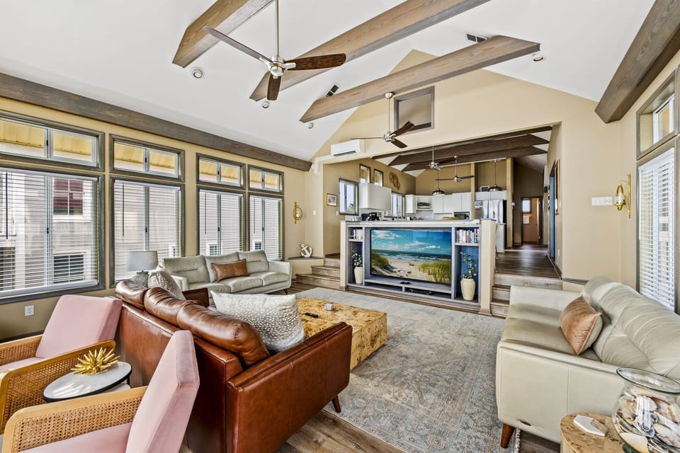 Unwind in style with this spacious living room featuring breath-taking ocean views.