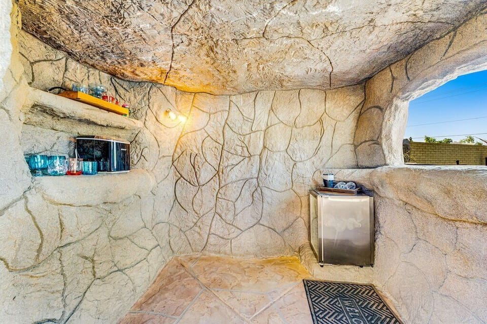 Inside of grotto bar complete with mini fridge, ice maker, glassware