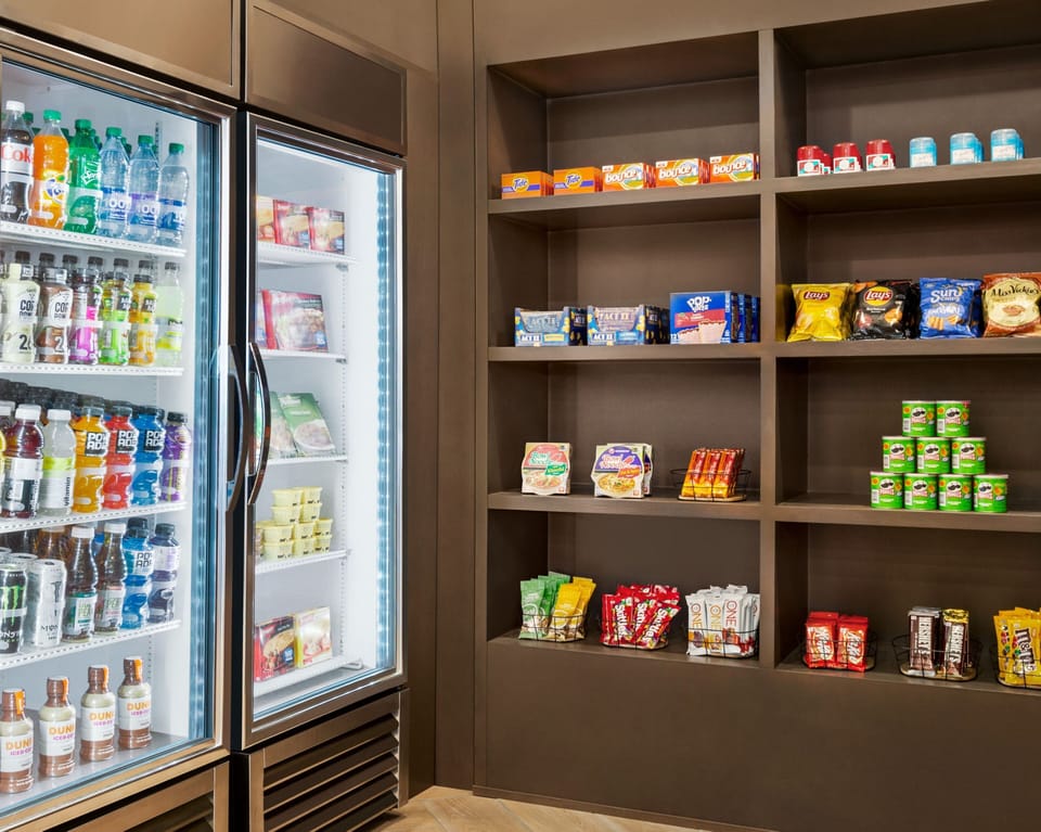 Well-stocked snack shop displaying beverages and various snack options.