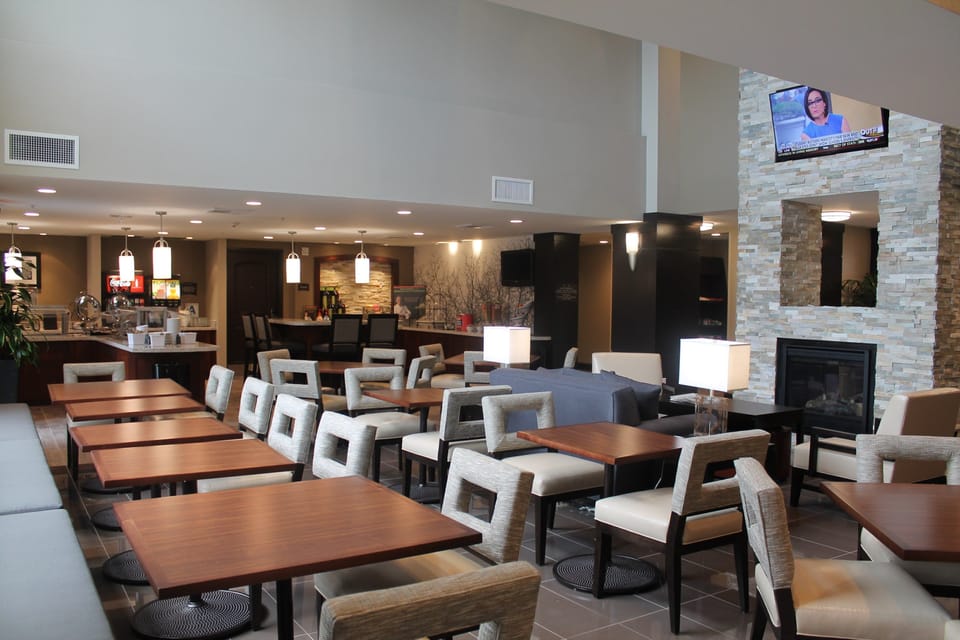 Open lounge area with tables, seating, and fireplace.