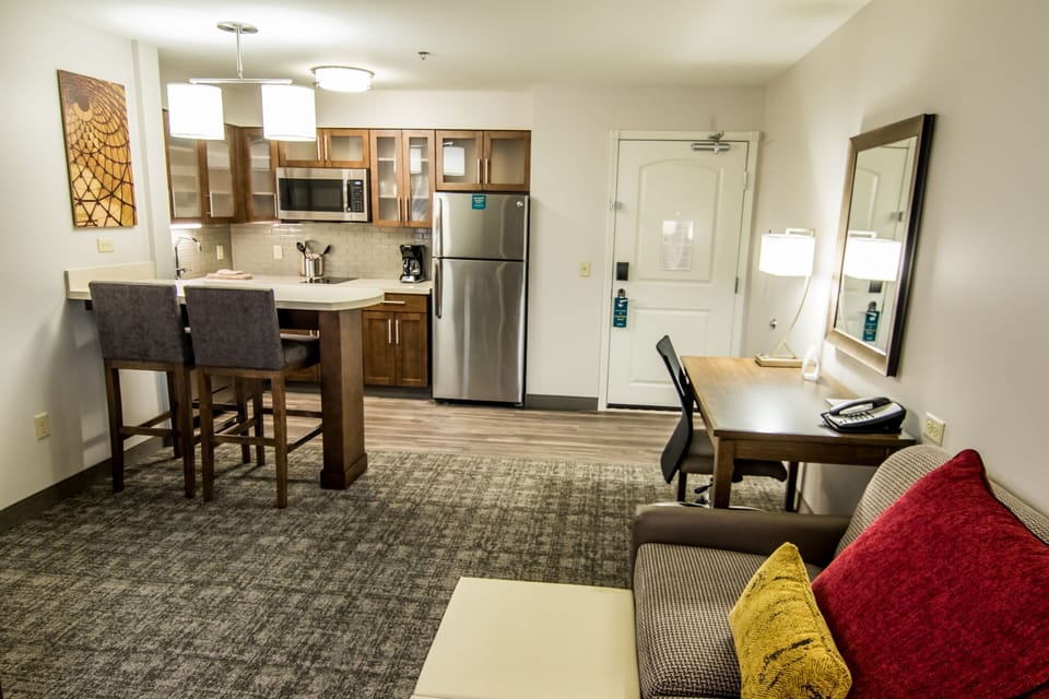 Fully equipped kitchen with stainless appliances and dining area.
