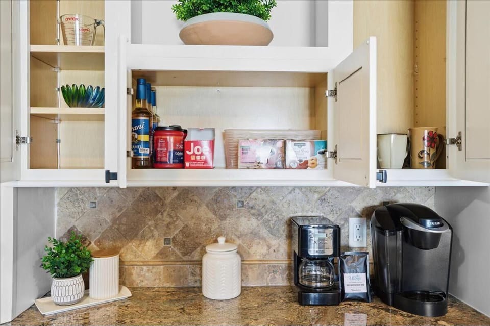 Bright kitchen nook with organized pantry and modern coffee station