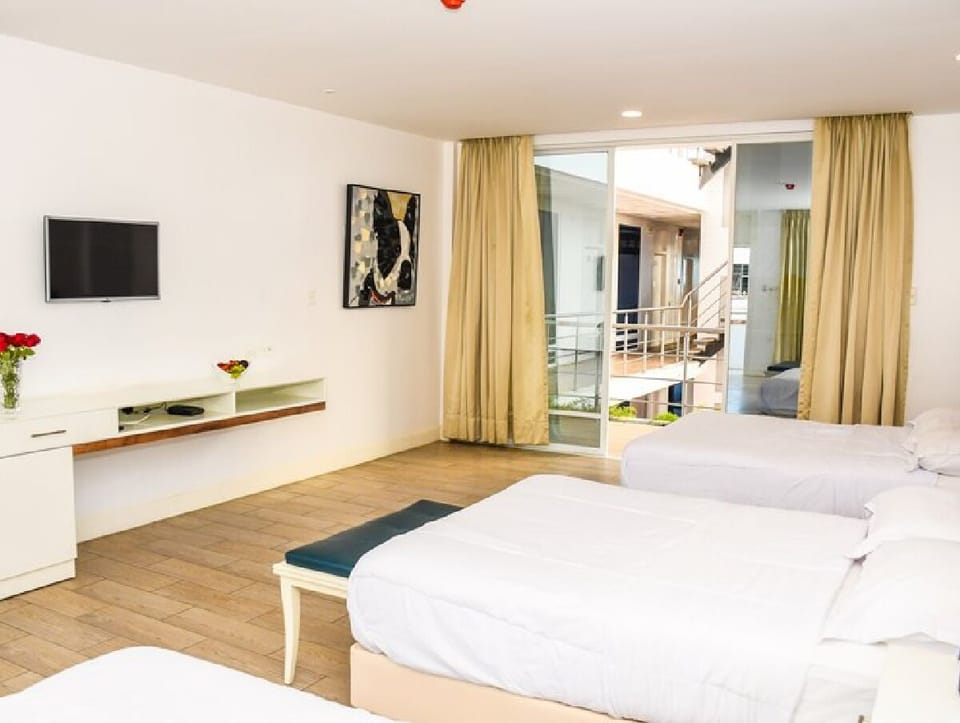 Family Triple Room, 1 Bedroom, Partial Ocean View | Down comforters, Select Comfort beds, in-room safe, desk