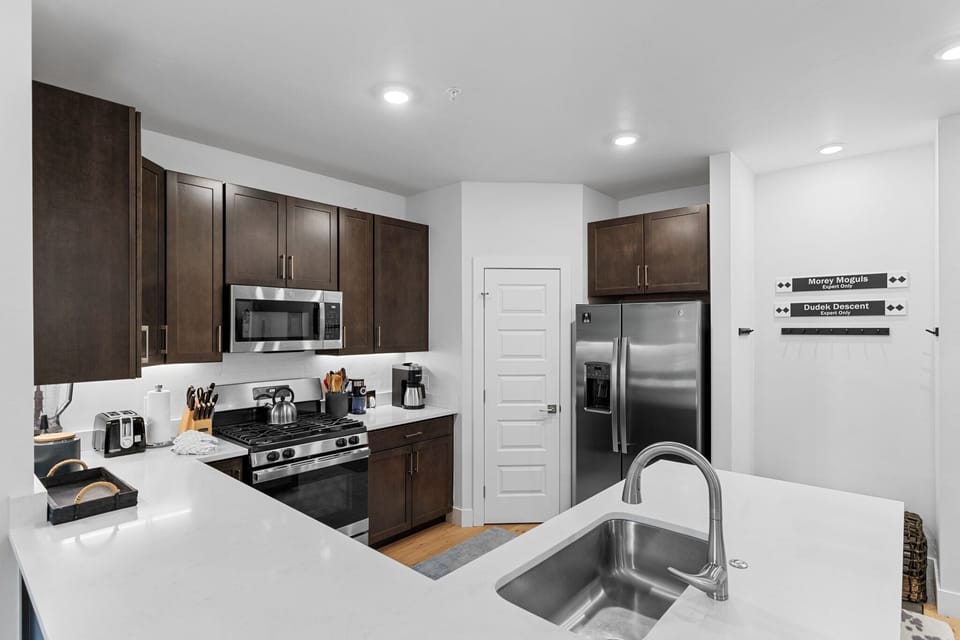 Cook memorable meals in your fully equipped kitchen, featuring sleek quartz countertops, stainless steel appliances, and all the tools you need.