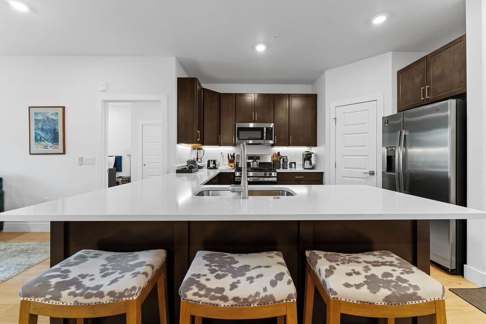Your modern kitchen awaits with sleek countertops, premium appliances, and a stylish island perfect for morning coffee or evening meals.