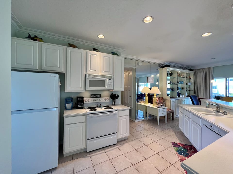 Your fully-equipped kitchen features white cabinetry, full appliances, and ample counter space for cooking memorable vacation meals together.