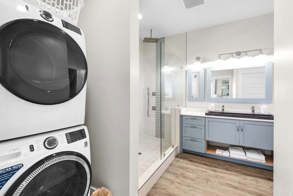 Primary ensuite bathroom with stackable washer/dryer