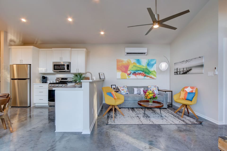 Open kitchen, dining & living room with queen size memory foam sleeper sofa.