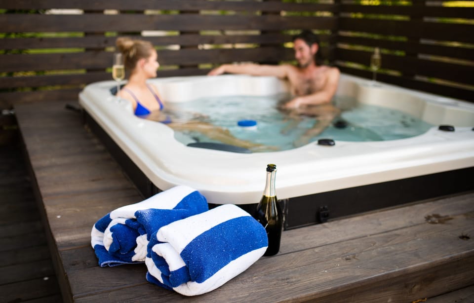 Hot tub, with seating for 6 and privacy fence.