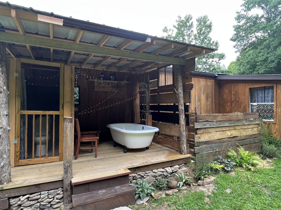 large outdoor soaking tub and shower (seasonal) and toilet