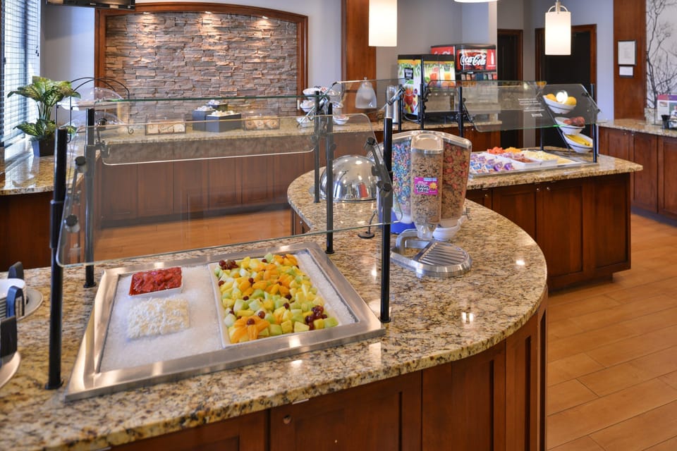 Breakfast buffet with fruit, cereals, and snack options.