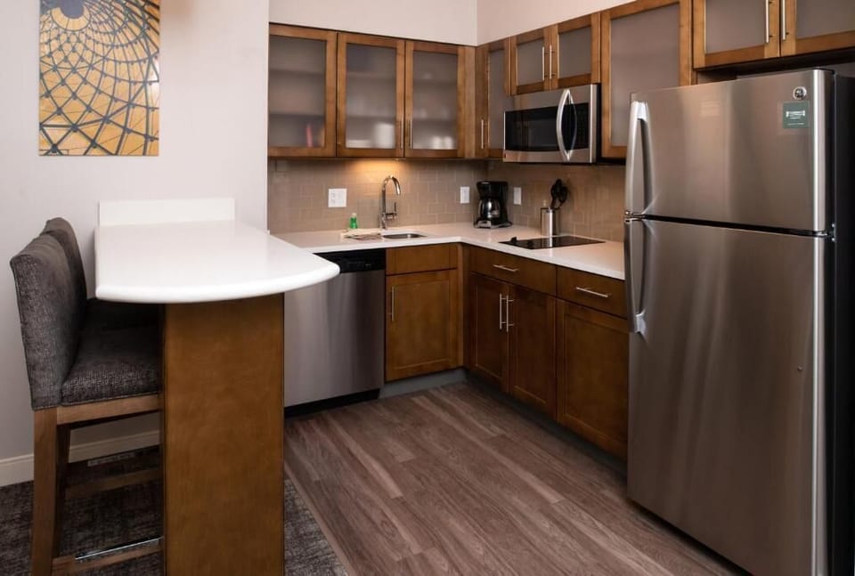 The kitchen features a full sized fridge and freezer and an oven