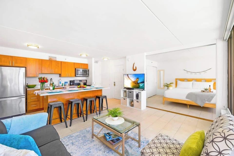 A sliding door separates the living room and has access to the bathroom as well, with a smart TV and standard cable.