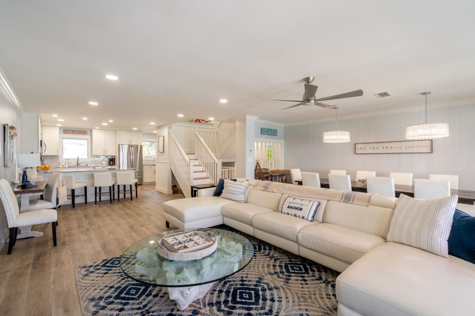 Stunning living area with a large sectional and dining table.