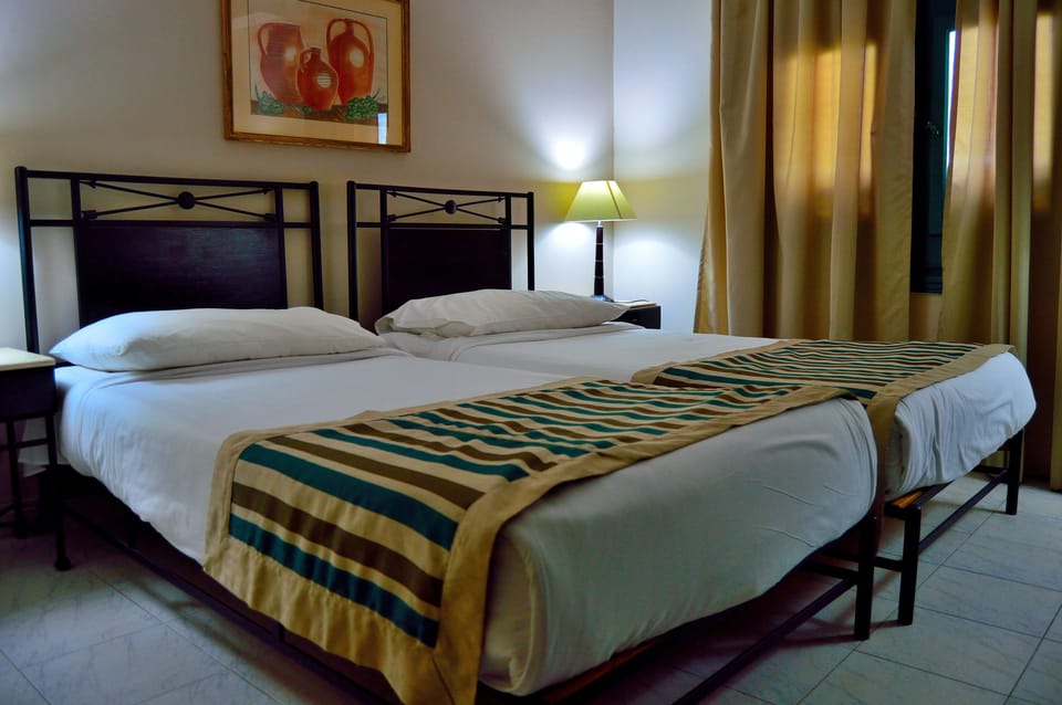 Twin Room (Saver) | Minibar, in-room safe, blackout drapes, bed sheets