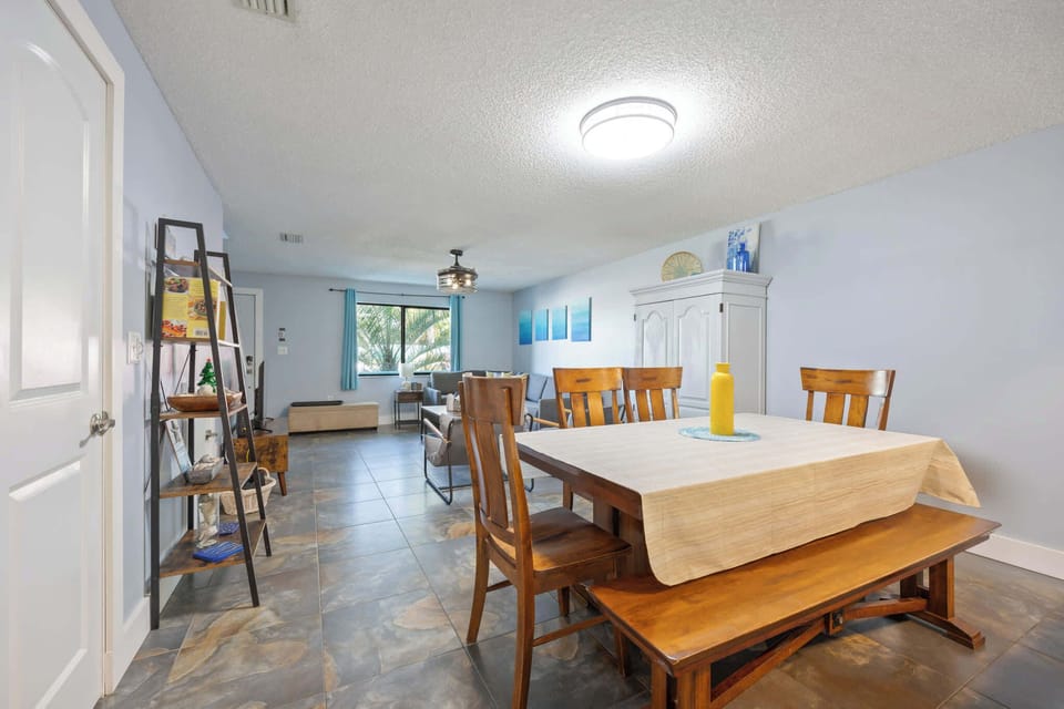 Spacious dining area with wooden furniture and natural light from the window