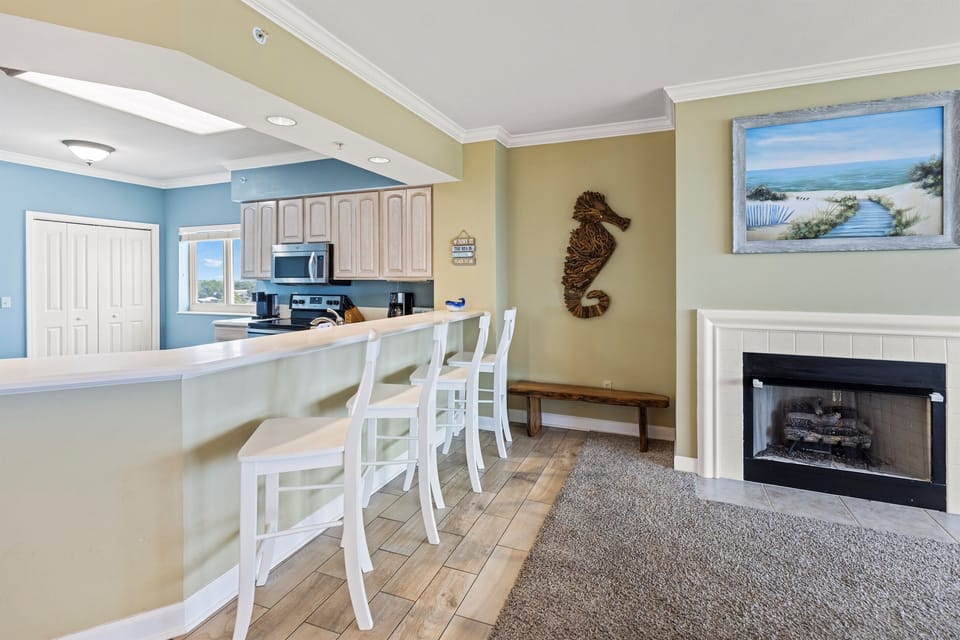 Your coastal retreat features a fully equipped kitchen and cozy fireplace, perfect for preparing meals and relaxing after beach days.