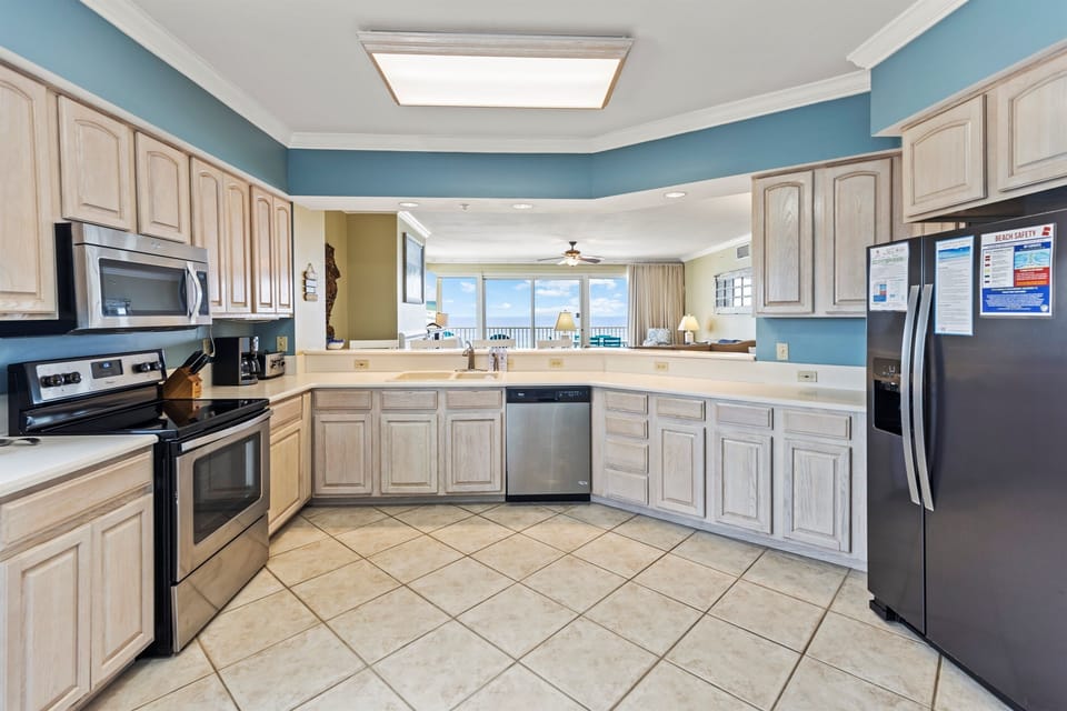 Your fully equipped kitchen features modern appliances and opens to an oceanfront living area with stunning views.