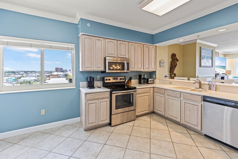 Cook with ease in your spacious kitchen featuring modern appliances and coastal-themed décor, while city views inspire your culinary adventures.