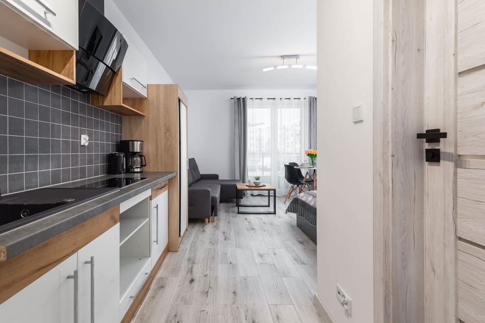 Kitchenette with kettle and refrigerator. 