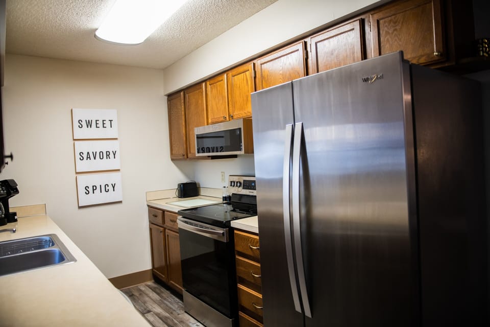 Galley kitchen with stainless steel.  Single cup and full pot coffee maker. 