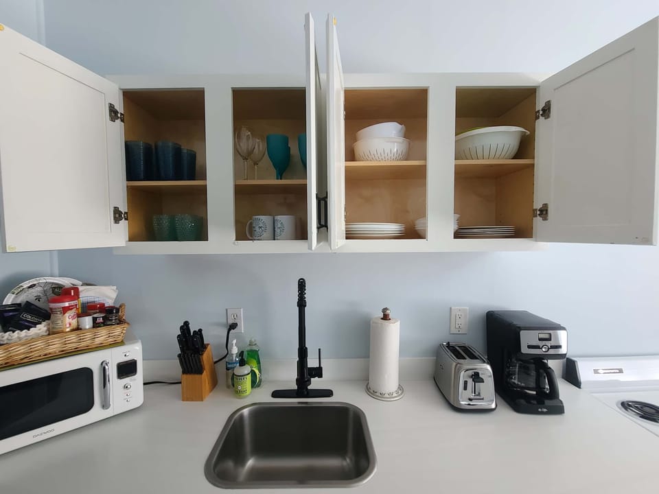 plates, bowls, cups, wine glasses, pots and pans included