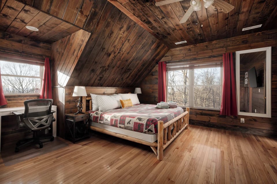 Primary Bedroom (2nd Floor) – A spacious loft suite with a king bed, large windows, and a built-in desk, perfect for work or relaxation.