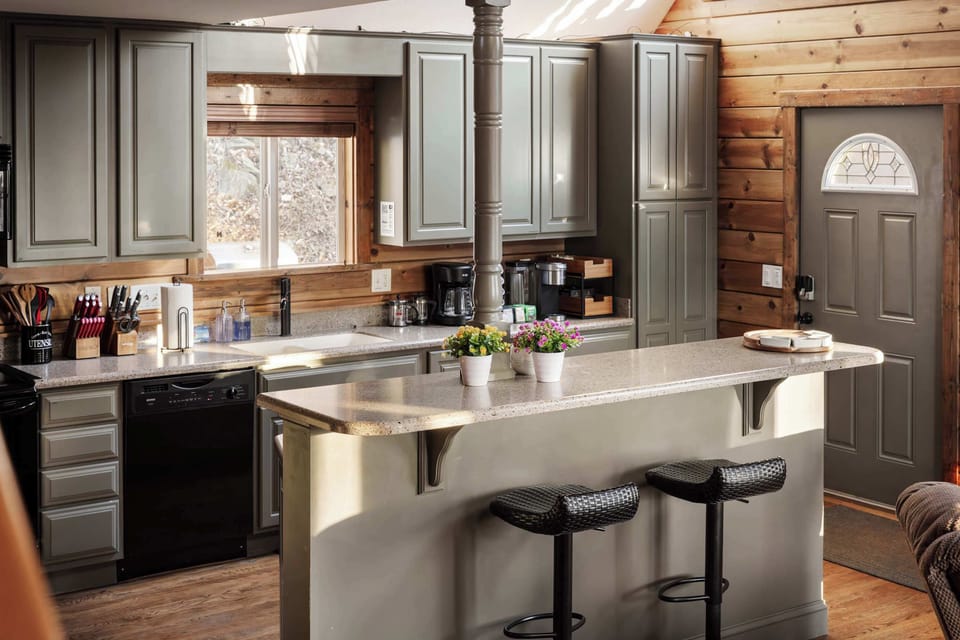Fully Equipped Kitchen – A spacious kitchen with modern appliances, ample counter space, and bar seating for a convenient cooking experience.