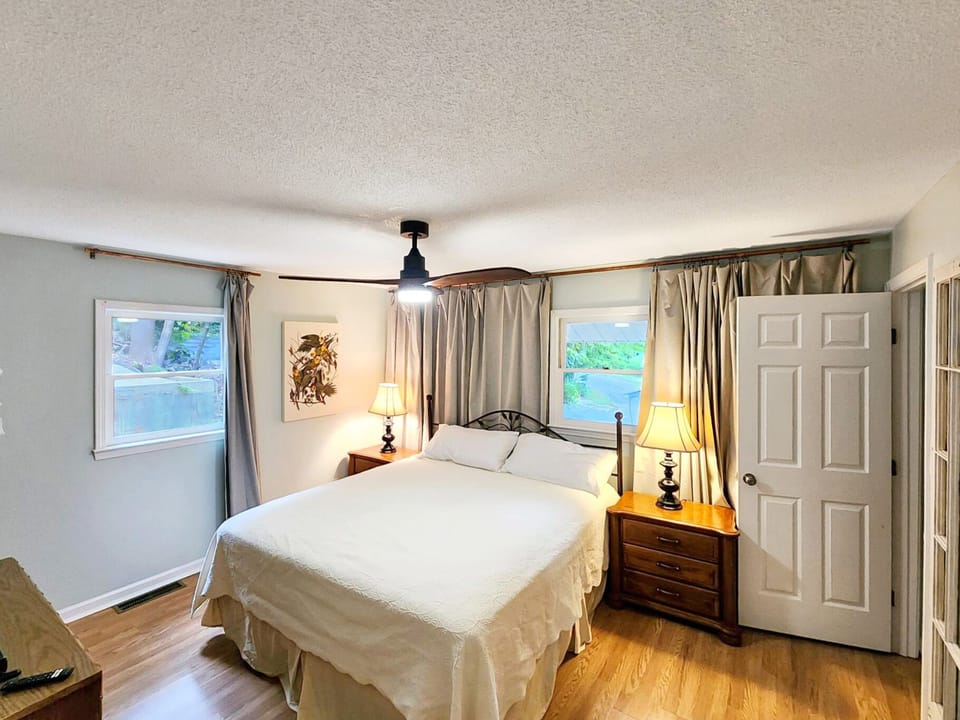 Cozy main bedroom with large TV, king size bed and attached full bath with tub