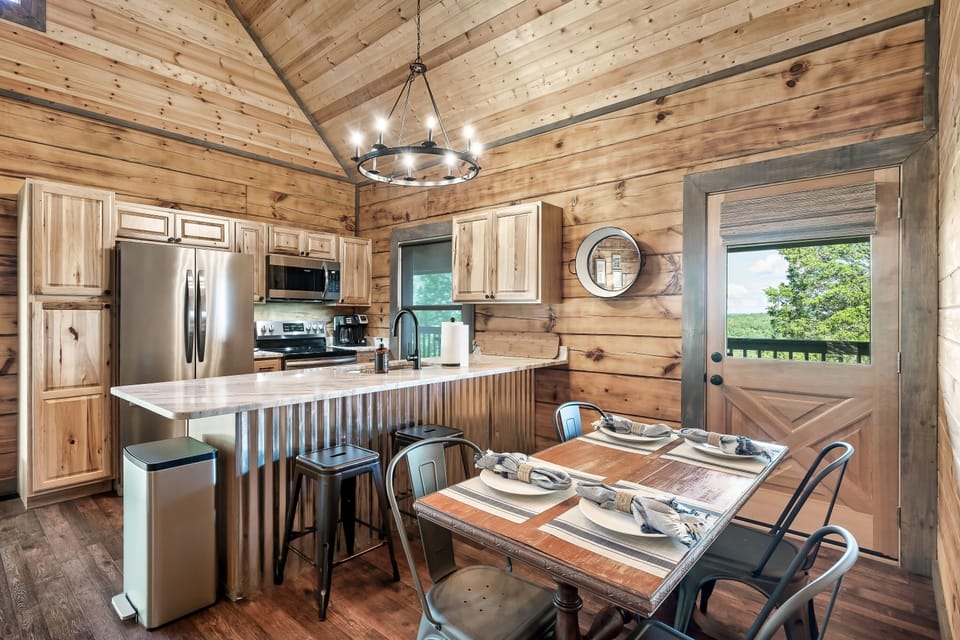 Kitchen island seating for two with chandelier, dining table for four and mountain cabin character