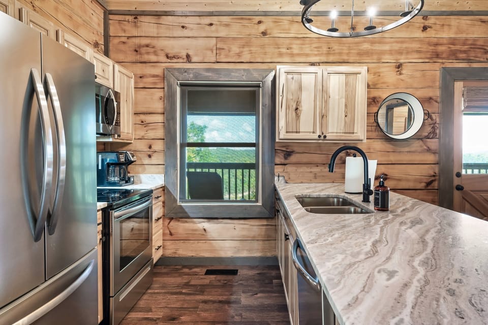 Fully equipped kitchen with new stainless appliances and marble counters