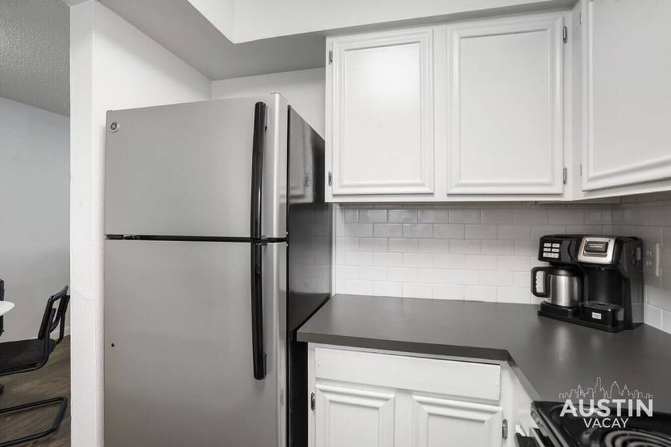 Kitchen with full refrigerator/freezer, coffee maker, and other essentials