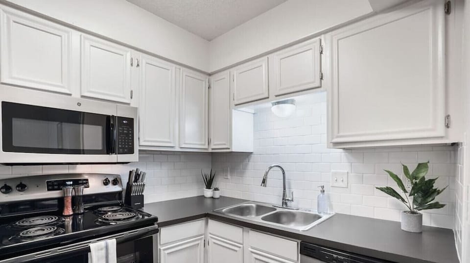 Kitchen with range, microwave, and dishwasher