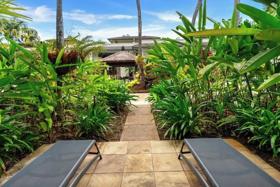 Sun loungers by the patio invite afternoons spent reading or resting in the breeze.