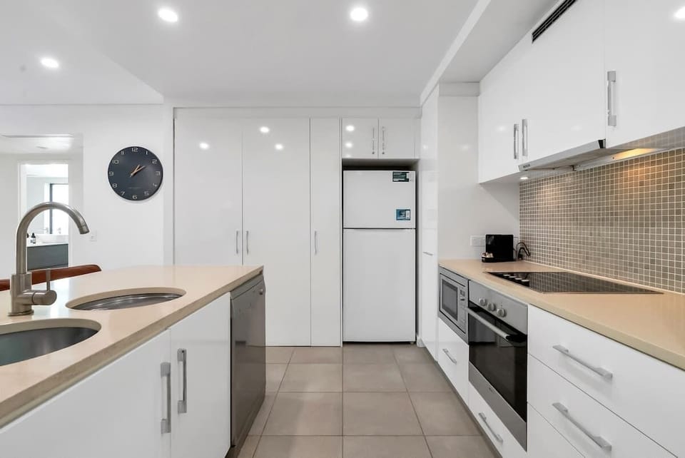 The kitchen is equipped with an oven, stove, microwave, and dishwasher, ready for at-home cooking.