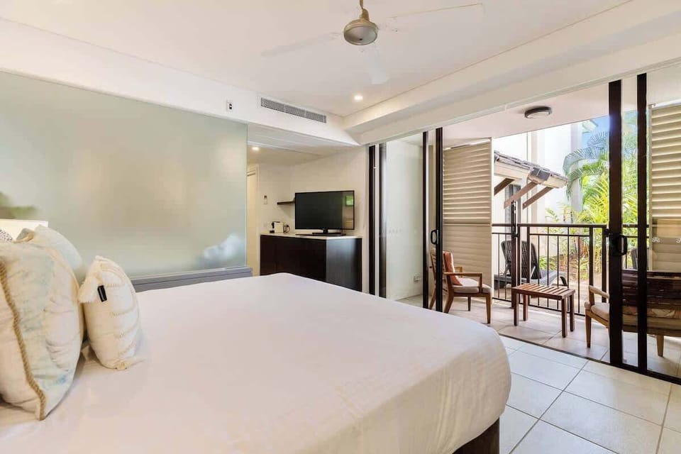 The primary bedroom is a restful retreat, fitted with a king-size bed and TV. Plus a Nespresso machine to whip up your morning espresso shot.