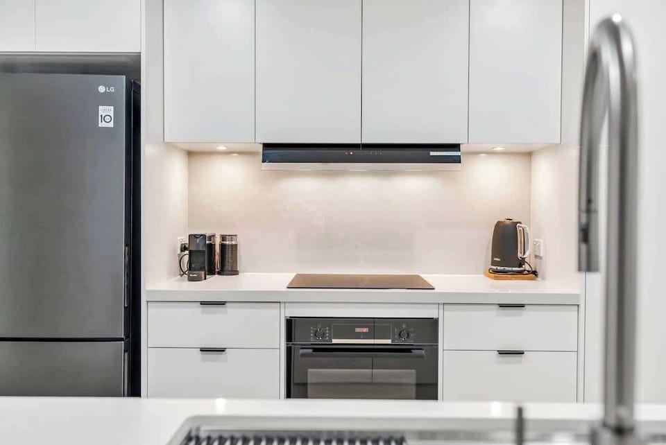 The brand-new gourmet kitchen is equipped with an induction cooktop and a sink water filter.