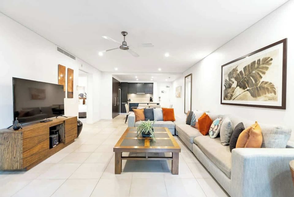 The large L-shaped couch provides plenty of room for everyone to relax while watching TV. 