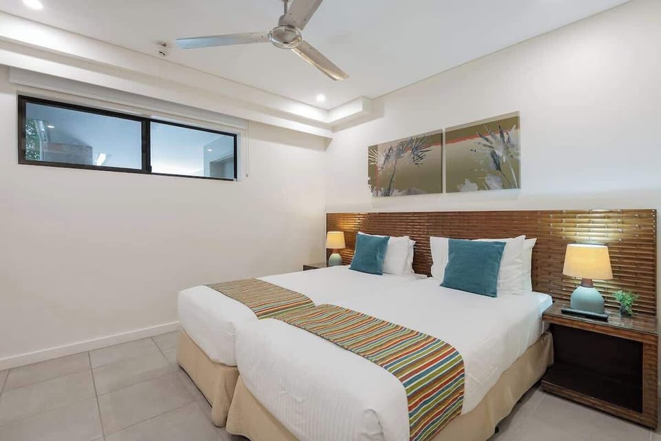 Second bedroom features two single beds which can be pushed together to create under a ceiling fan and A/C for ultimate comfort.